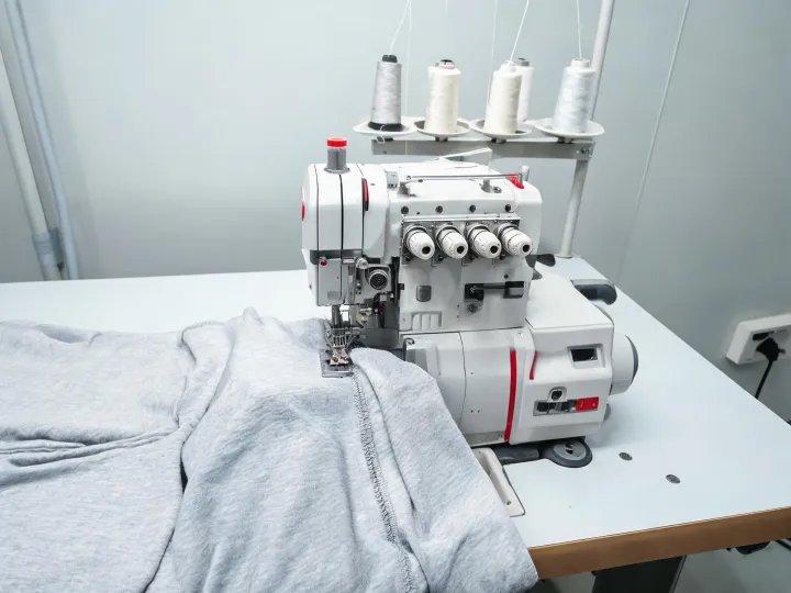 Industrial overlock workstation handling knit garment panels